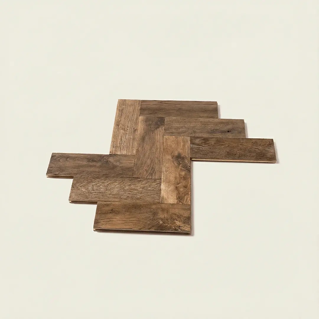 Reclaimed oak flooring and chestnut boards showing herringbone and plank patterns with original weathered surface and natural tonal variation