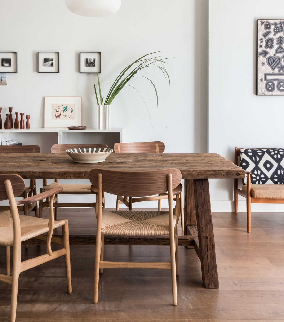 Perlas Reclaimed Oak Dining Table – with woven-seat chairs and framed prints