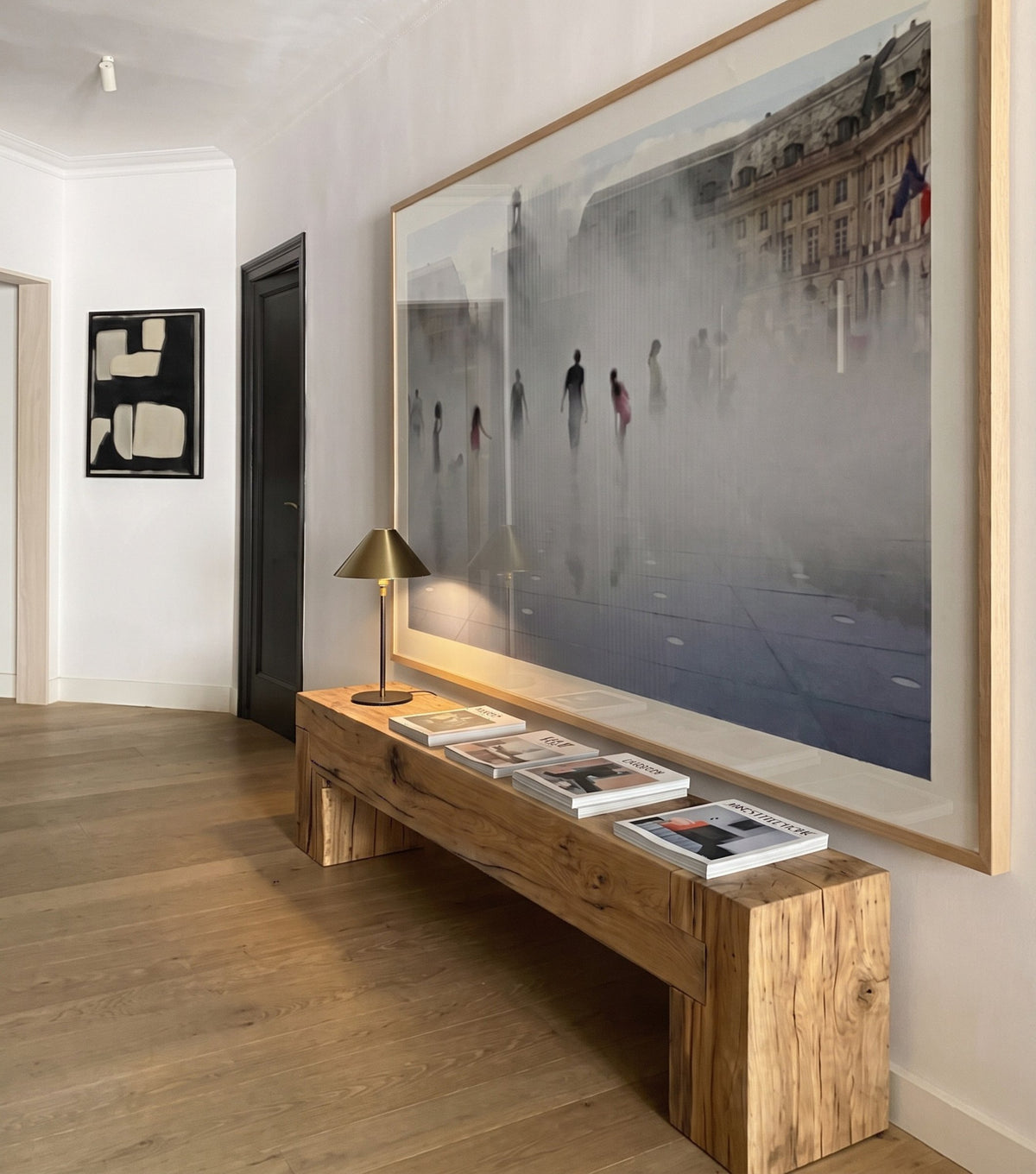 Sella Reclaimed Oak Bench – in a hallway beneath large artwork