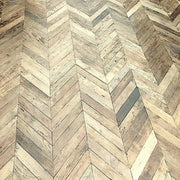 Reclaimed oak chevron flooring with weathered grain in a room setting