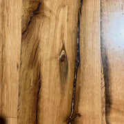 Reclaimed oak and chestnut plank flooring with original patina in a room setting