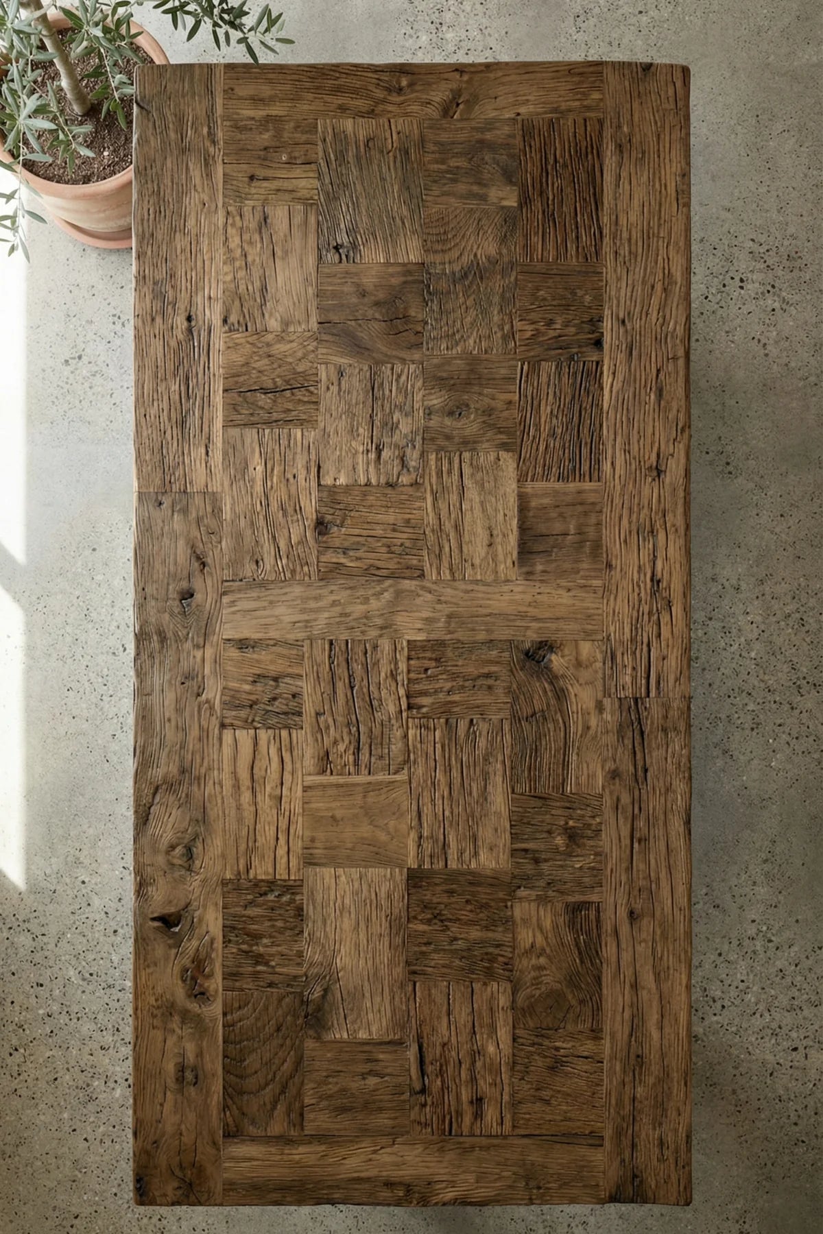 Close-up of reclaimed oak tabletop surface showing natural imperfections, filled knots and deep wood tones