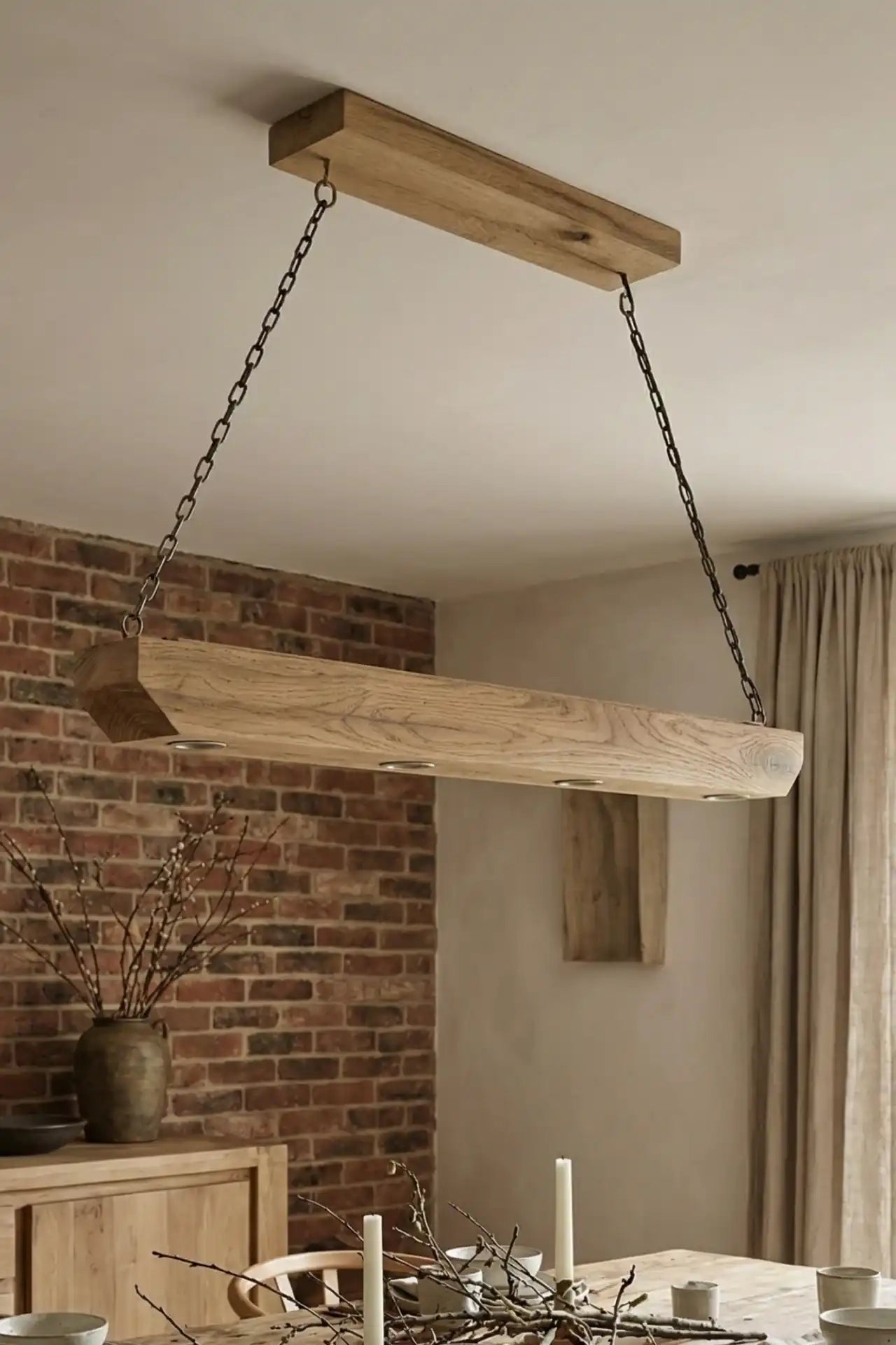 Reclaimed wood beam chandelier sanded finish in dining room with exposed brick wall