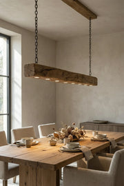Reclaimed oak beam pendant light — original surface — installed in a dining room interior