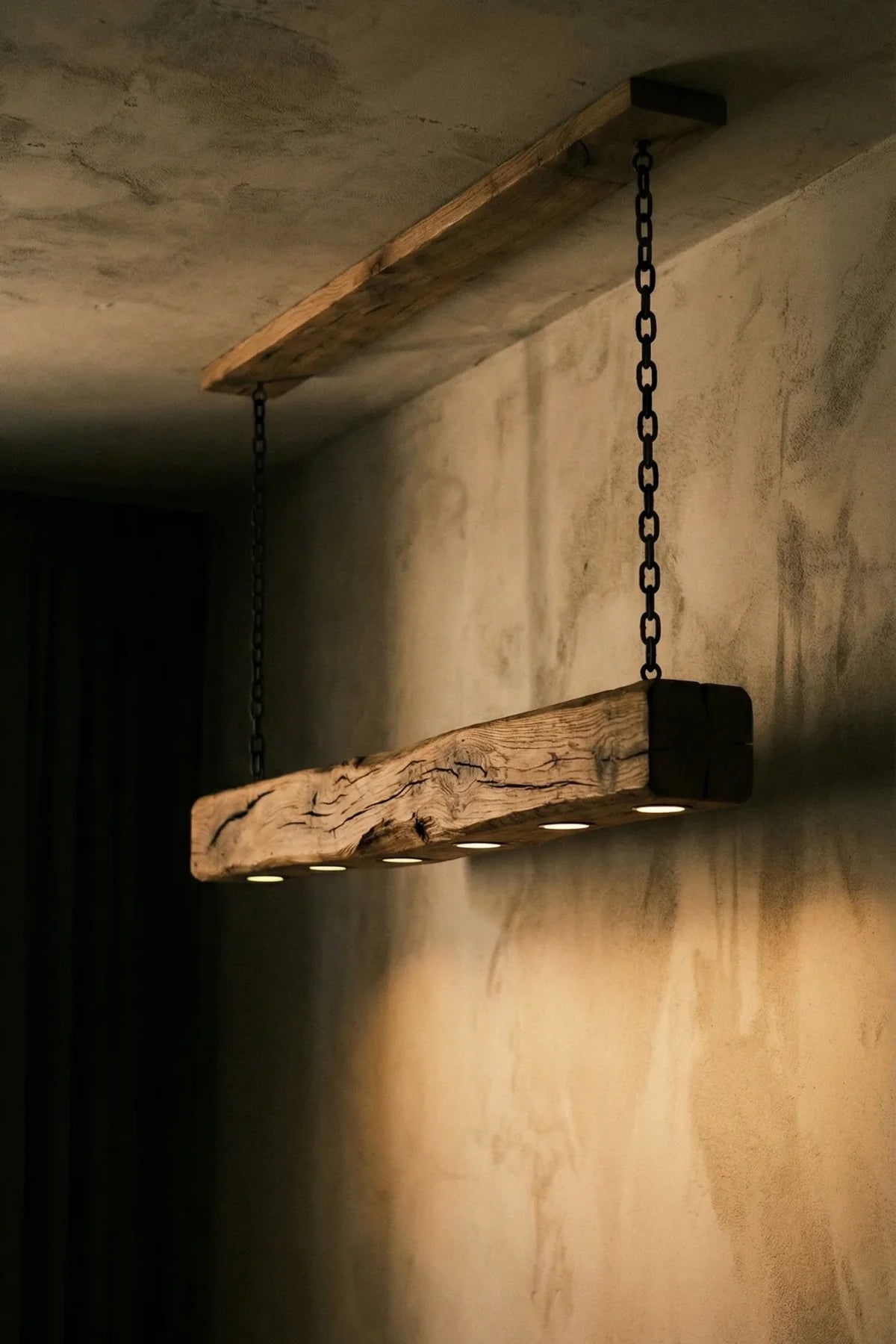Close-up of original reclaimed oak beam surface showing deep grain, natural checks, and tonal variation