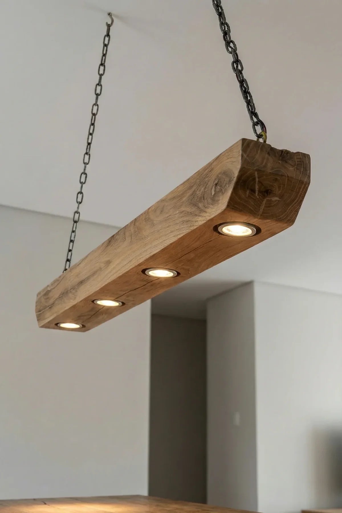 Beam pendant light — three-quarter angle view showing GU10 fittings along planed oak beam underside