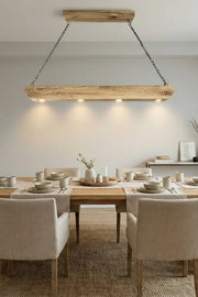 Reclaimed oak beam pendant light installed above a dining table in an interior setting