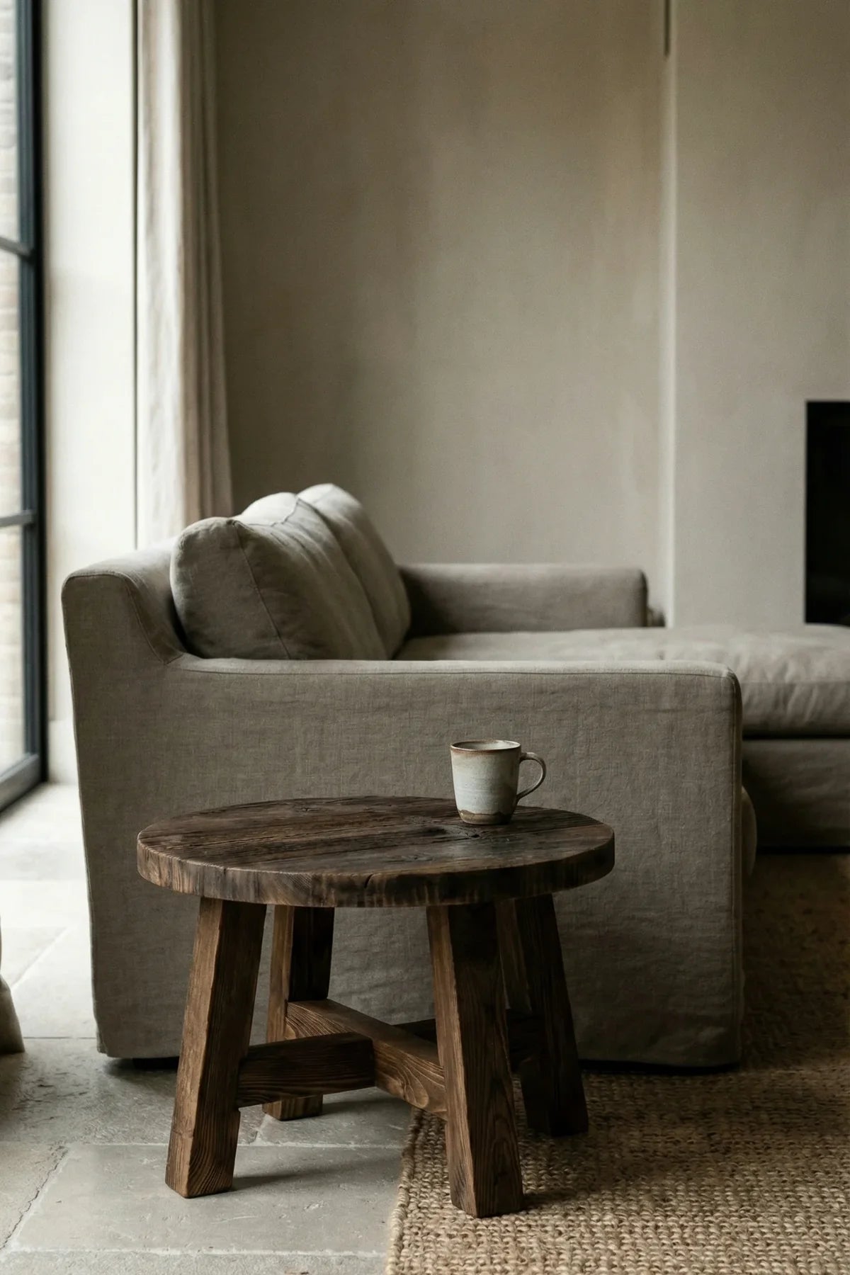 Dekelia side table — three-quarter angle view showing X-frame oak base and round tabletop