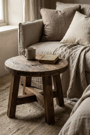Dekelia reclaimed oak side table styled beside a sofa in a living room interior