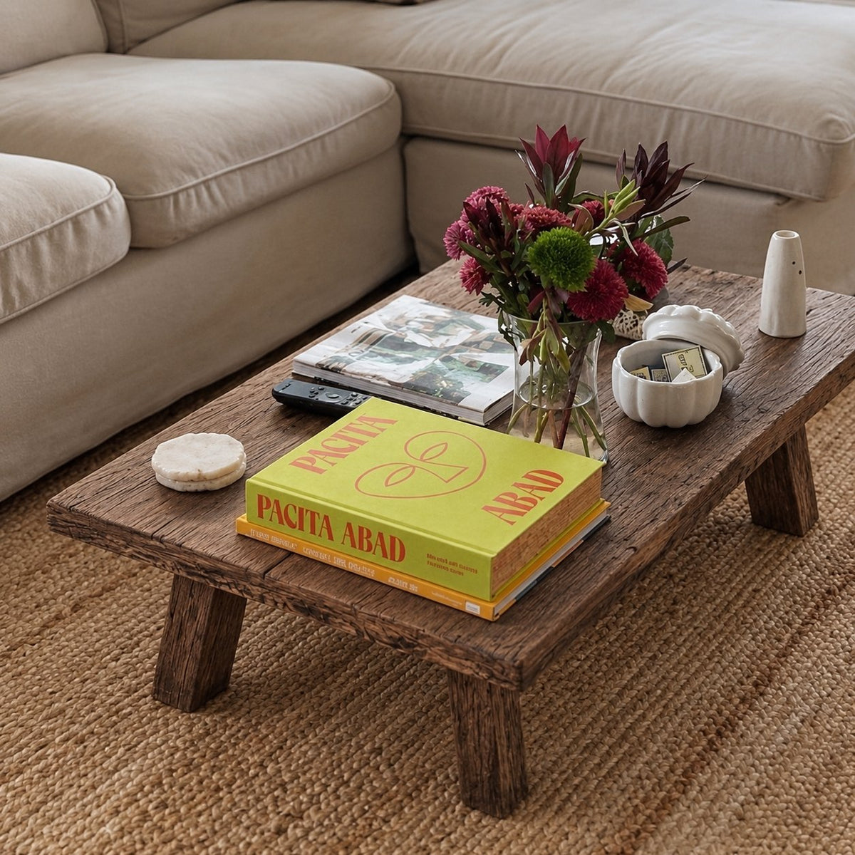 Massalia Reclaimed Oak Coffee Table – in a living room with flowers