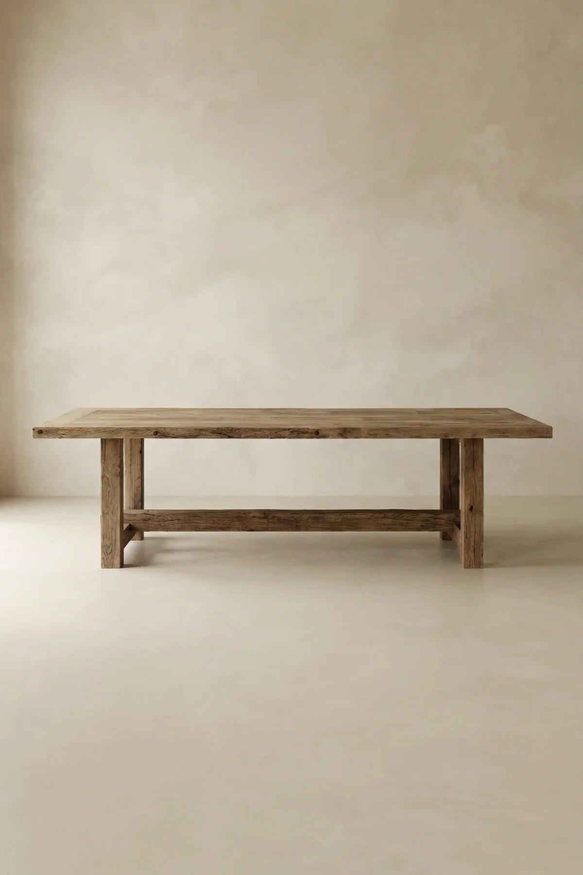 Matera dining table — front view showing deep-brushed reclaimed oak surface and structural beam legs