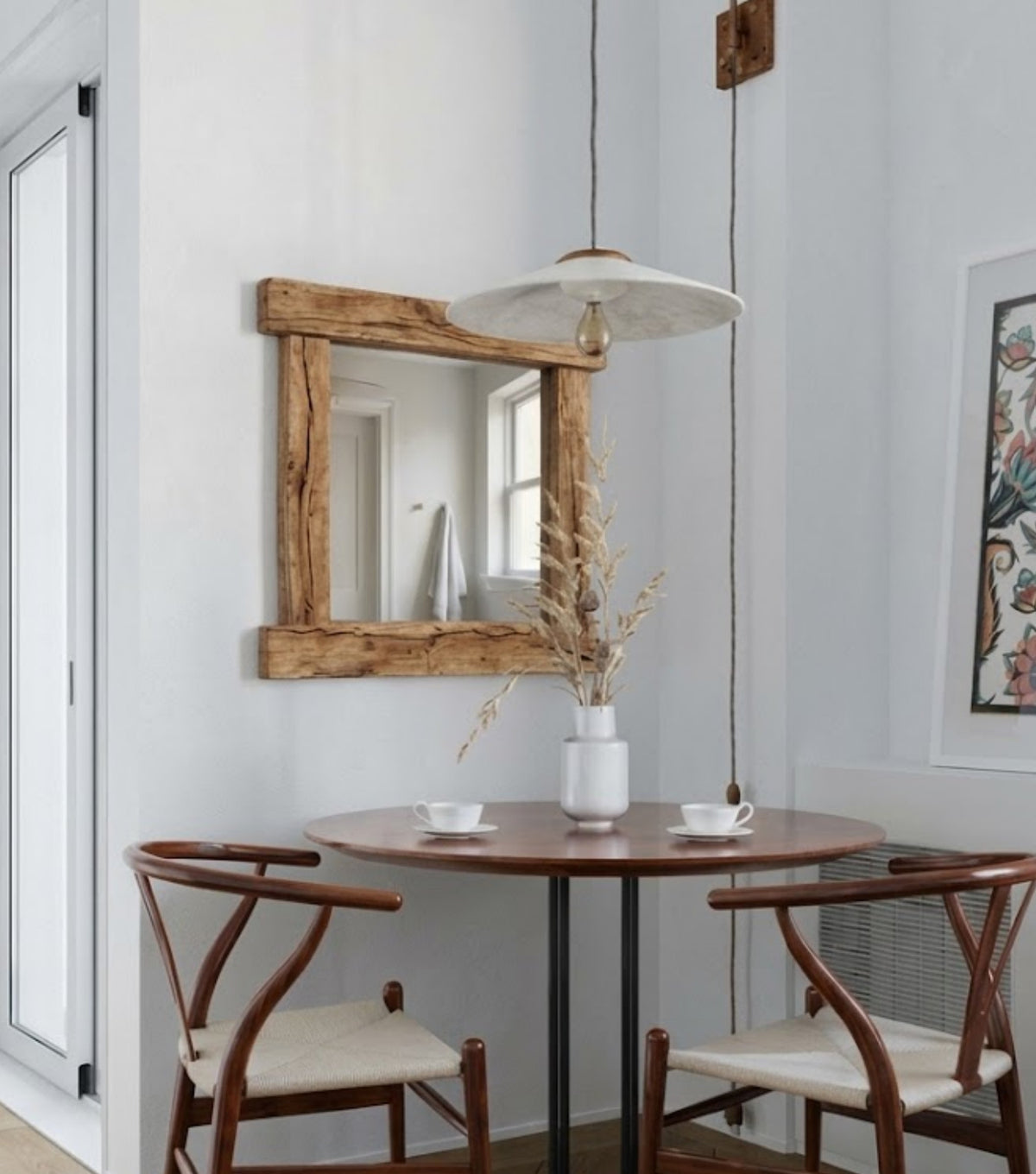 Nova Reclaimed Oak Mirror – beside a dining table with wishbone chairs