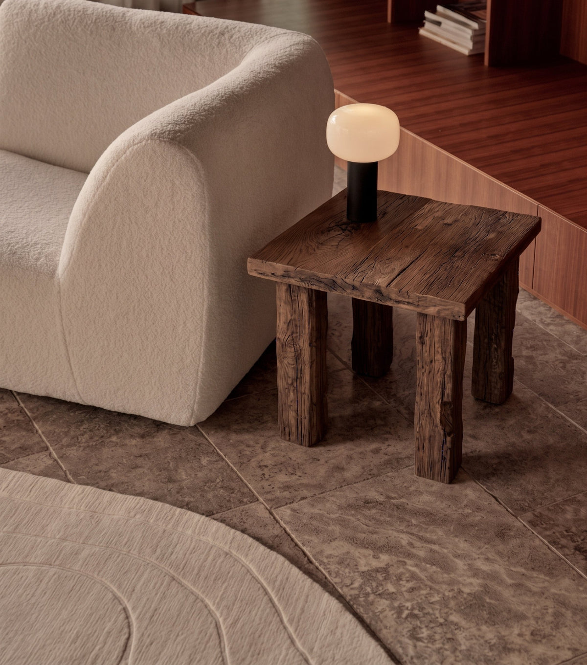 Ostia Reclaimed Oak Side Table – beside a cream bouclé armchair with a table lamp