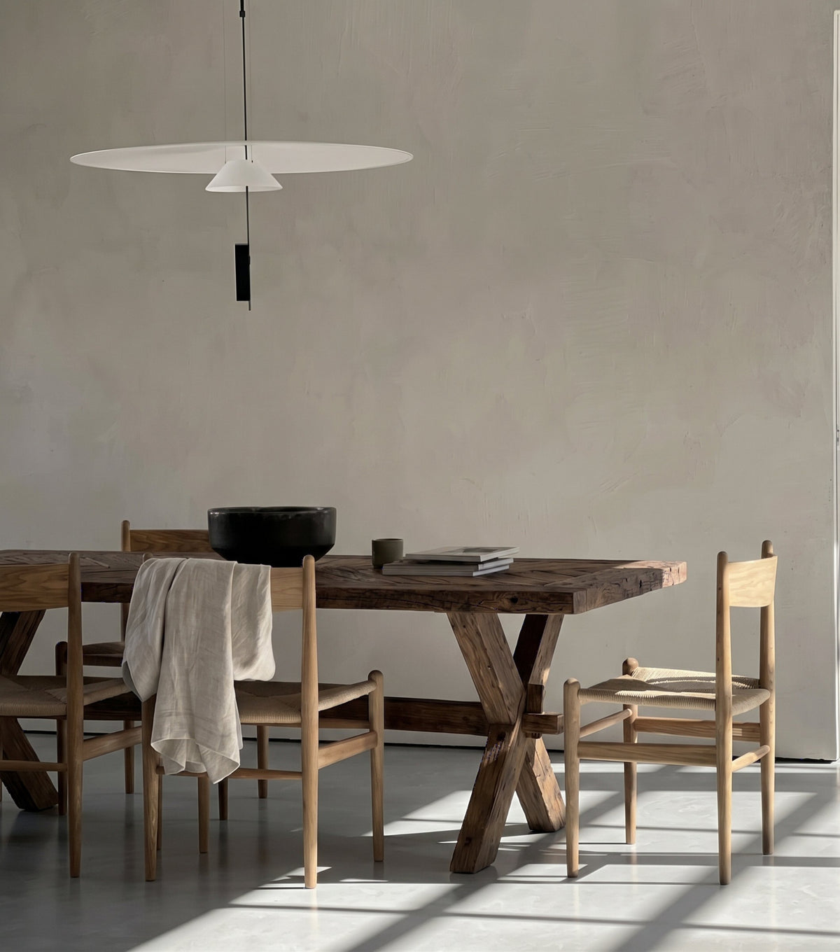 Petra Reclaimed Oak Herringbone Dining Table – with oak chairs beneath a disc pendant