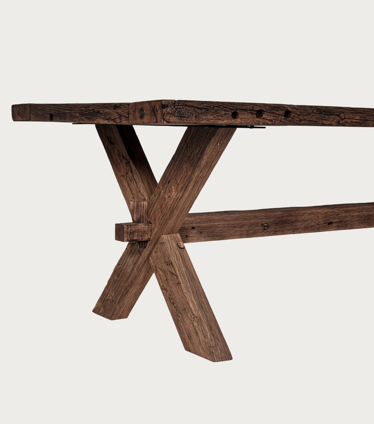 Petra Reclaimed Oak Herringbone Dining Table – detail of the crossed trestle leg