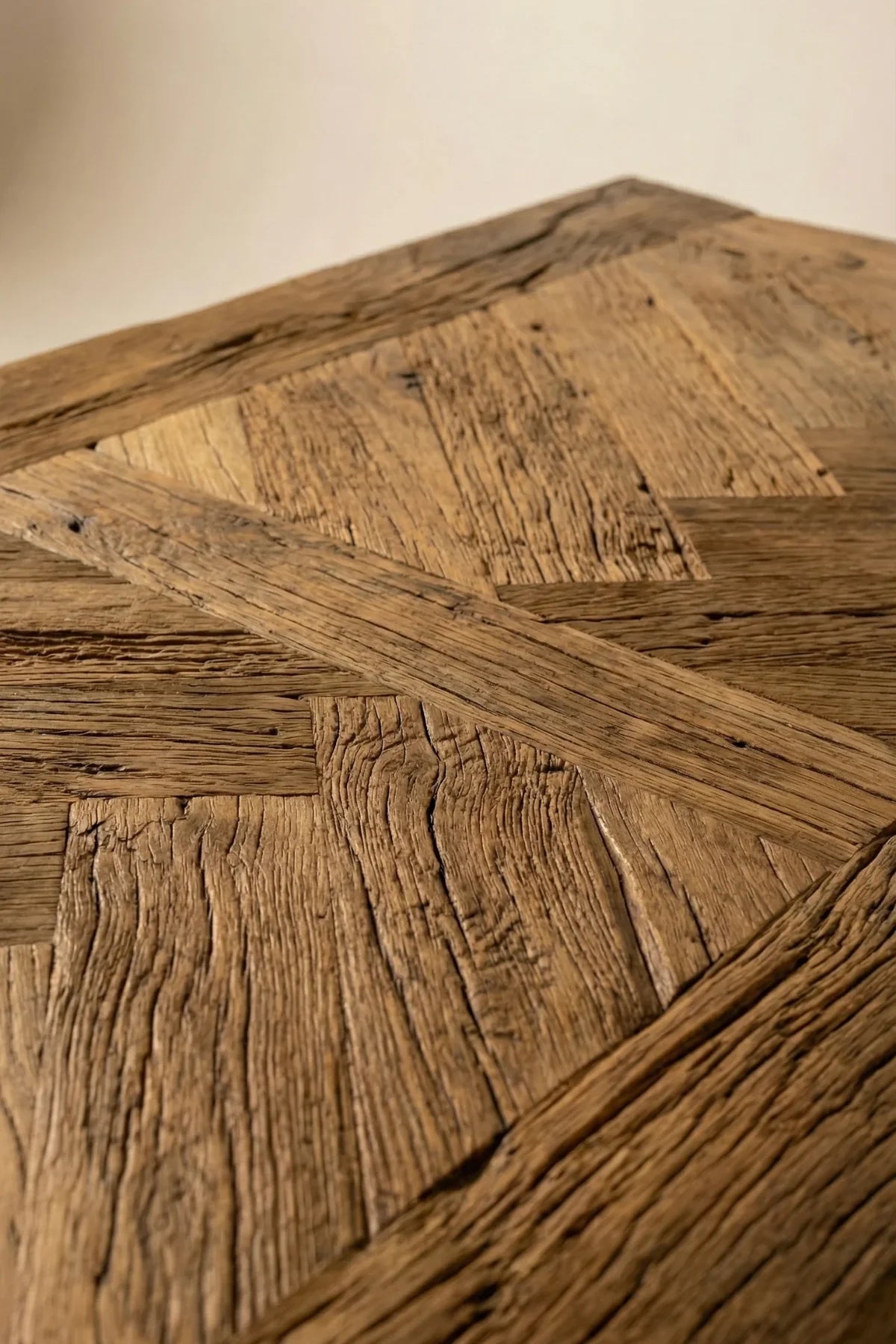 Close-up of Petra herringbone tabletop showing natural knots, grain direction changes and filled imperfections