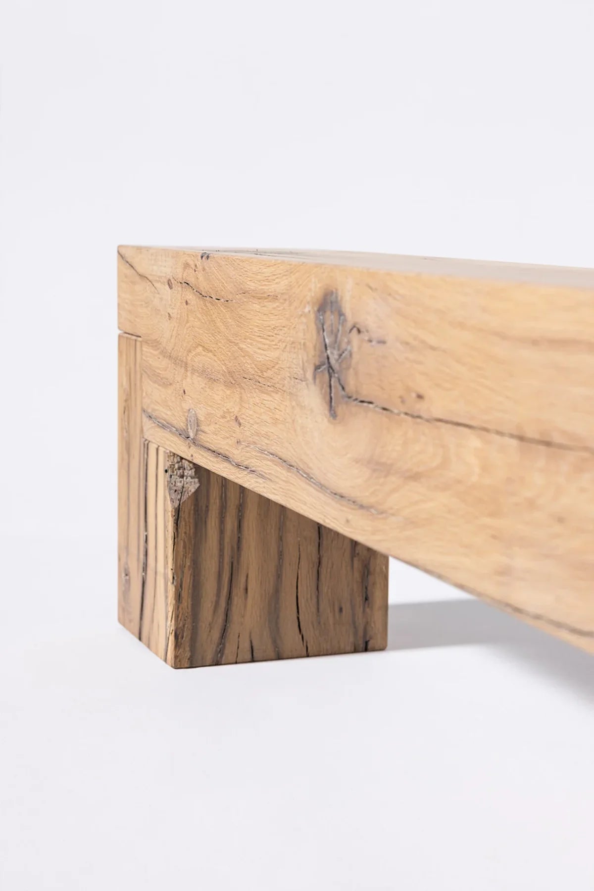 Sable bench — three-quarter angle showing solid block legs and brushed oak surface