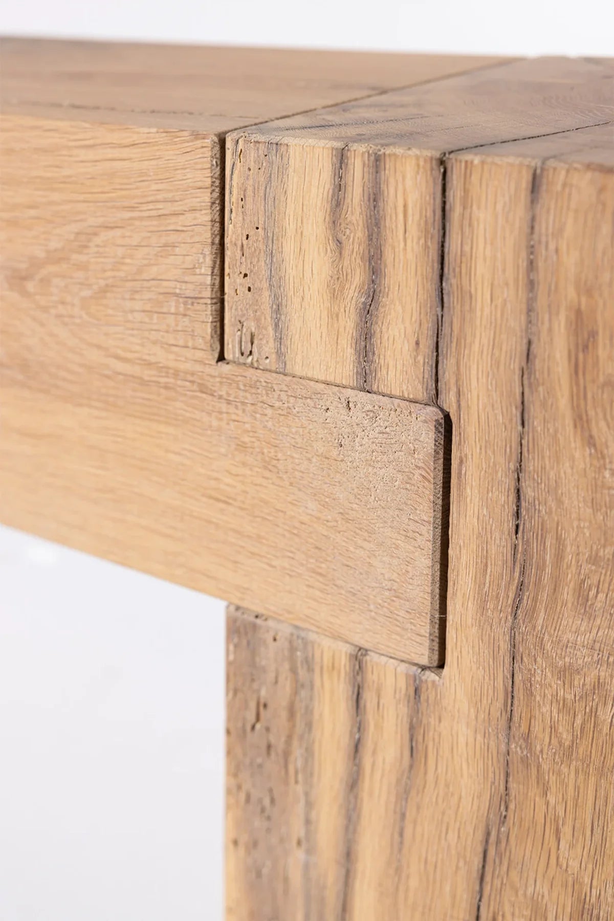 Natural knot and grain detail in the reclaimed oak surface of the Sable bench