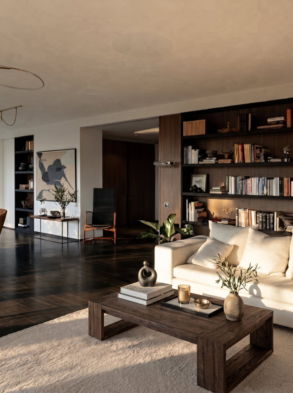 Sardis Reclaimed Oak Coffee Table – in an open living room with a bookcase