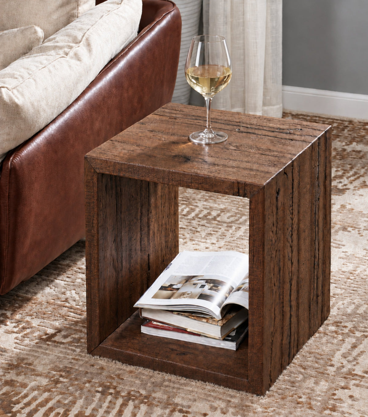 Sardis Reclaimed Oak Side Table – beside a leather sofa holding magazines