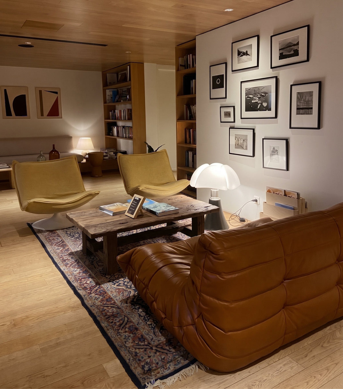 Segesta Reclaimed Oak Coffee Table – in front of a leather sofa and gallery wall