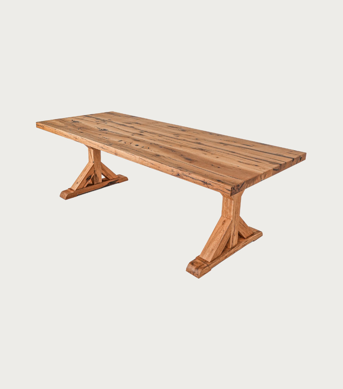 Serra Reclaimed Oak Dining Table – angled view of the top and trestle base