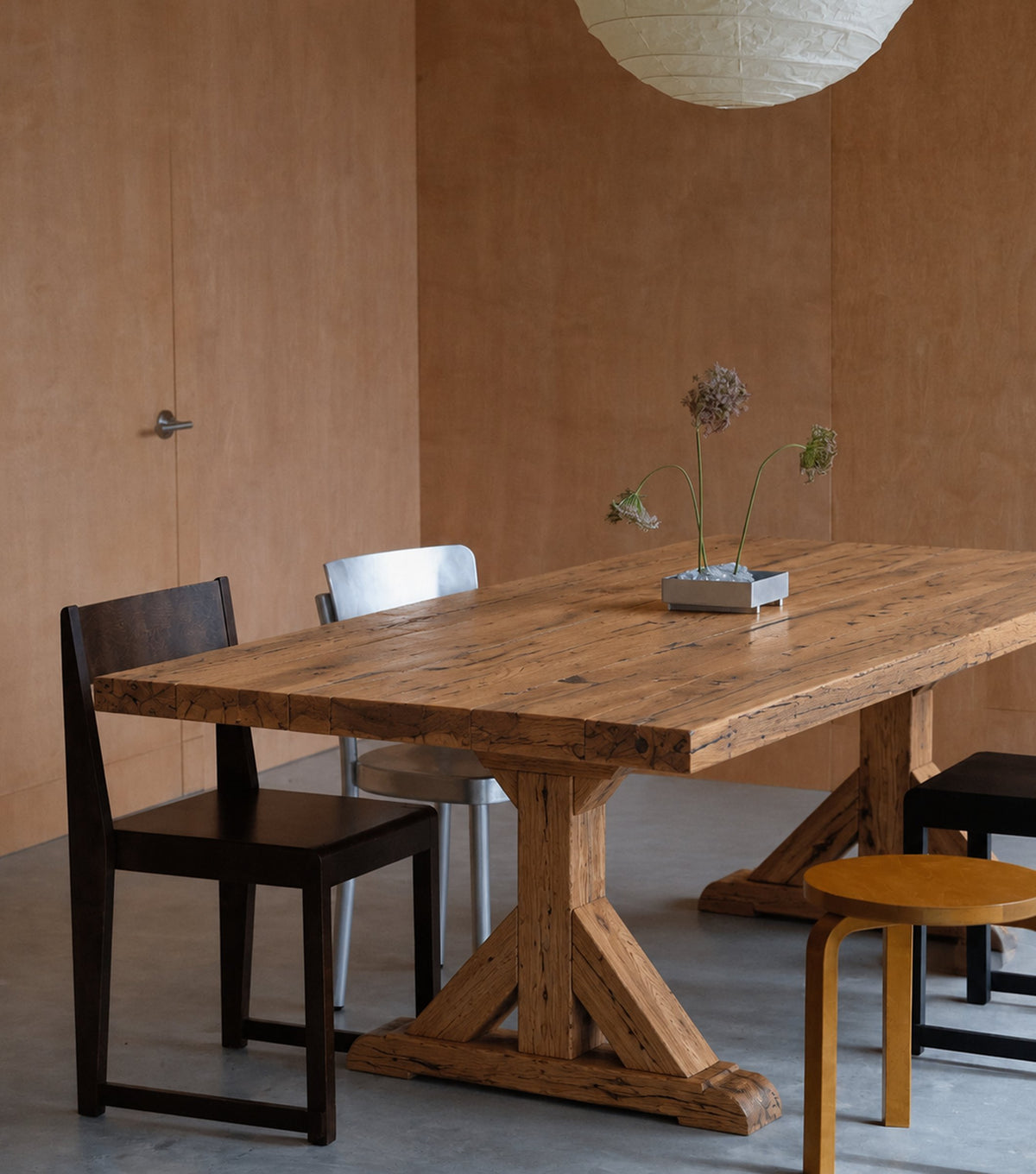 Serra Reclaimed Oak Dining Table – with dark chairs in a warm dining room