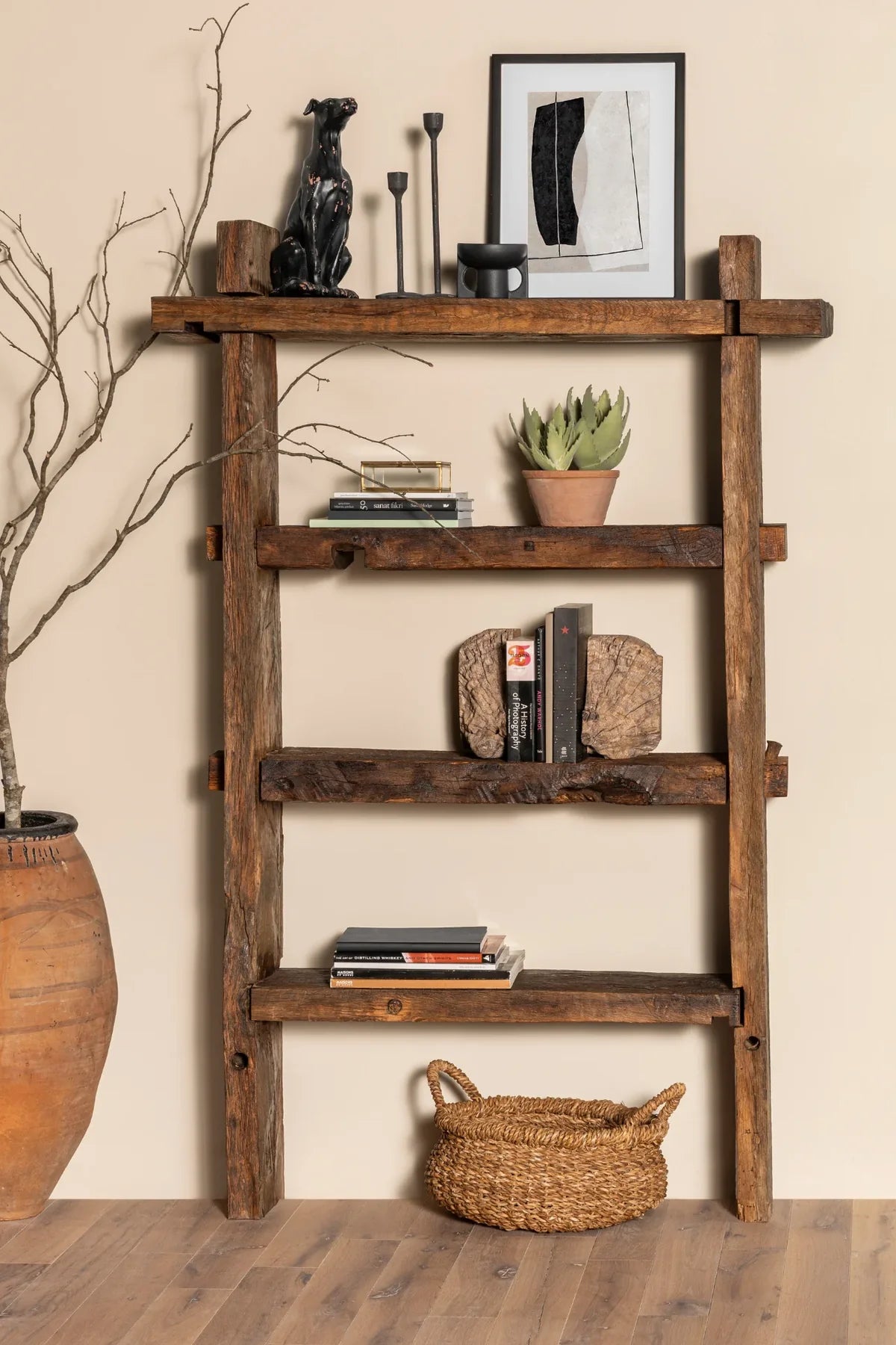 Solstice reclaimed oak bookcase styled with books and objects in a living room setting