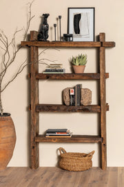 Solstice reclaimed oak bookcase styled with books and objects in a living room setting