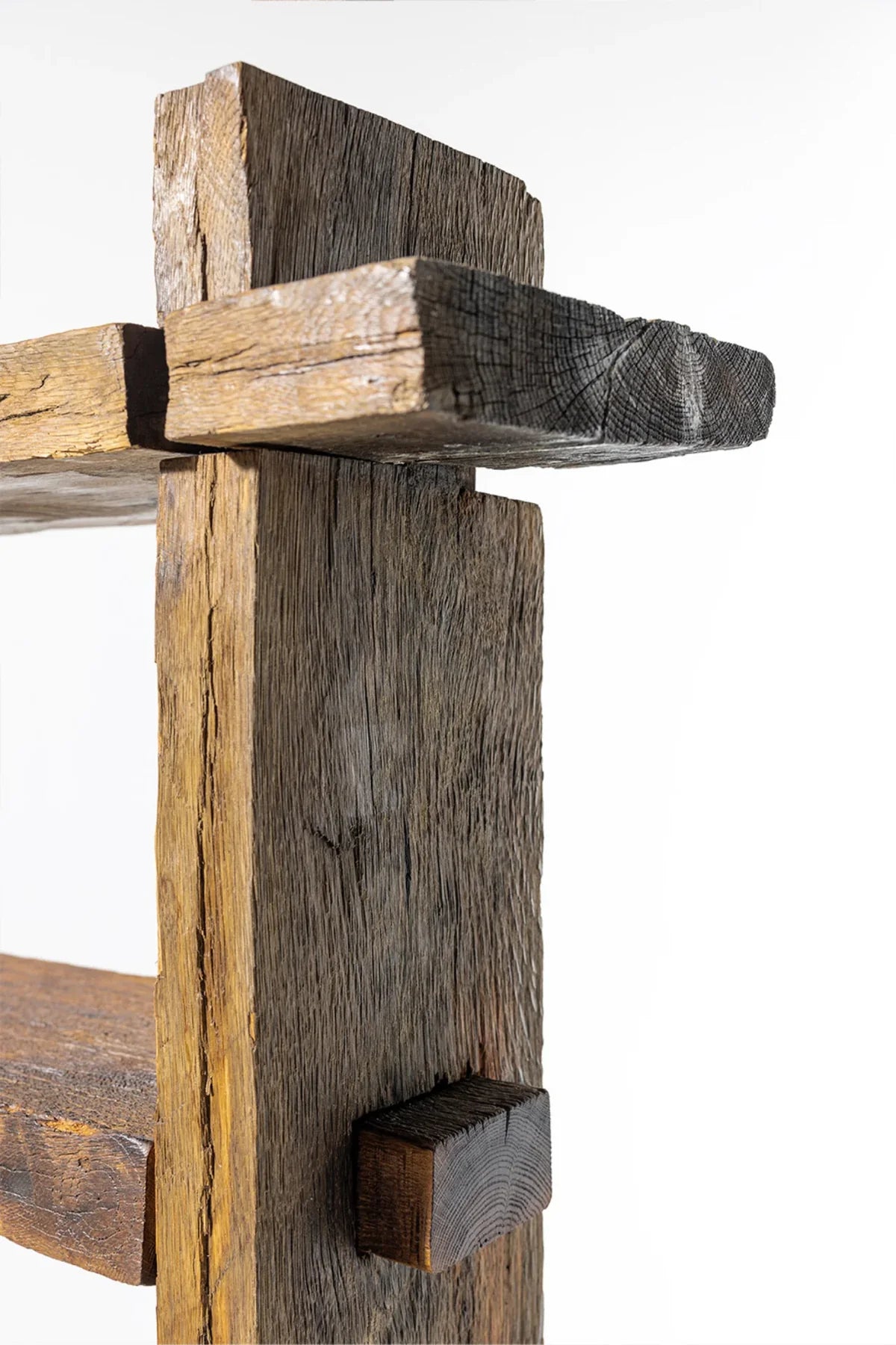 Surface detail of Solstice bookcase shelf showing natural knots and weathered reclaimed oak grain
