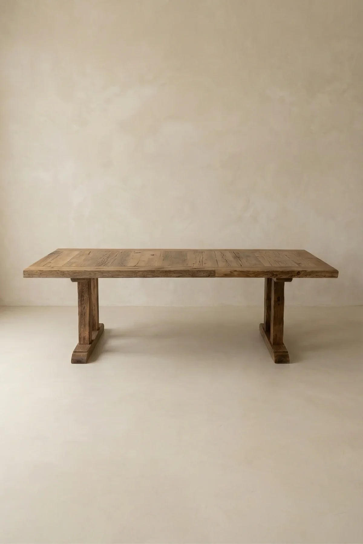 Stoa dining table — front view showing deep-brushed reclaimed oak surface and structural beam legs