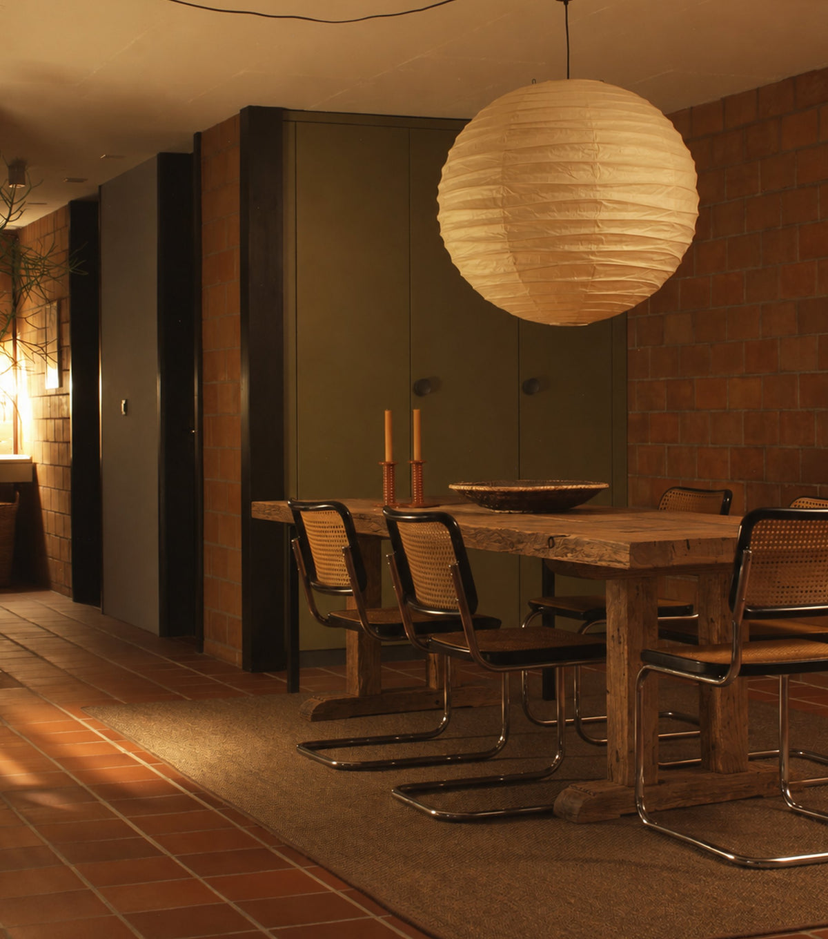 Stoa Reclaimed Oak Dining Table – in a warm dining room with a paper lantern