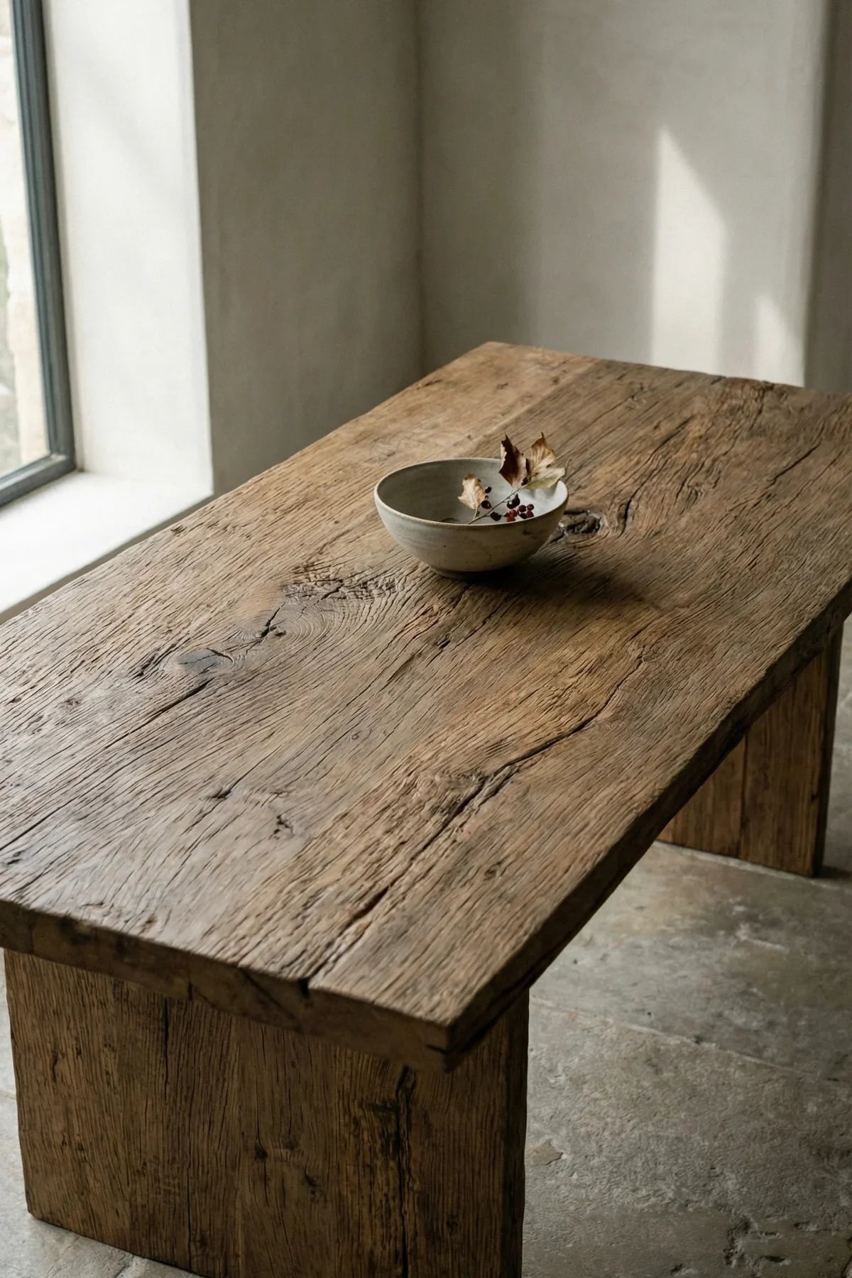 Thebes dining table — three-quarter angle view highlighting natural raw oak surface and leg construction