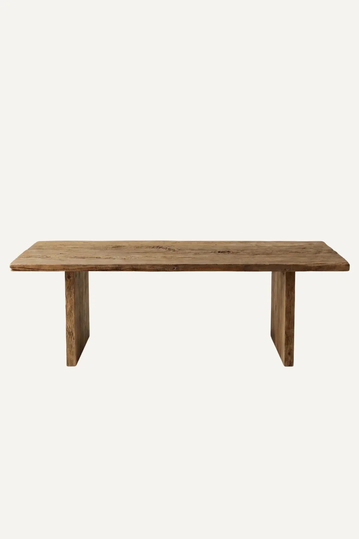 Thebes dining table — front view showing lightly brushed reclaimed oak surface and structural beam legs
