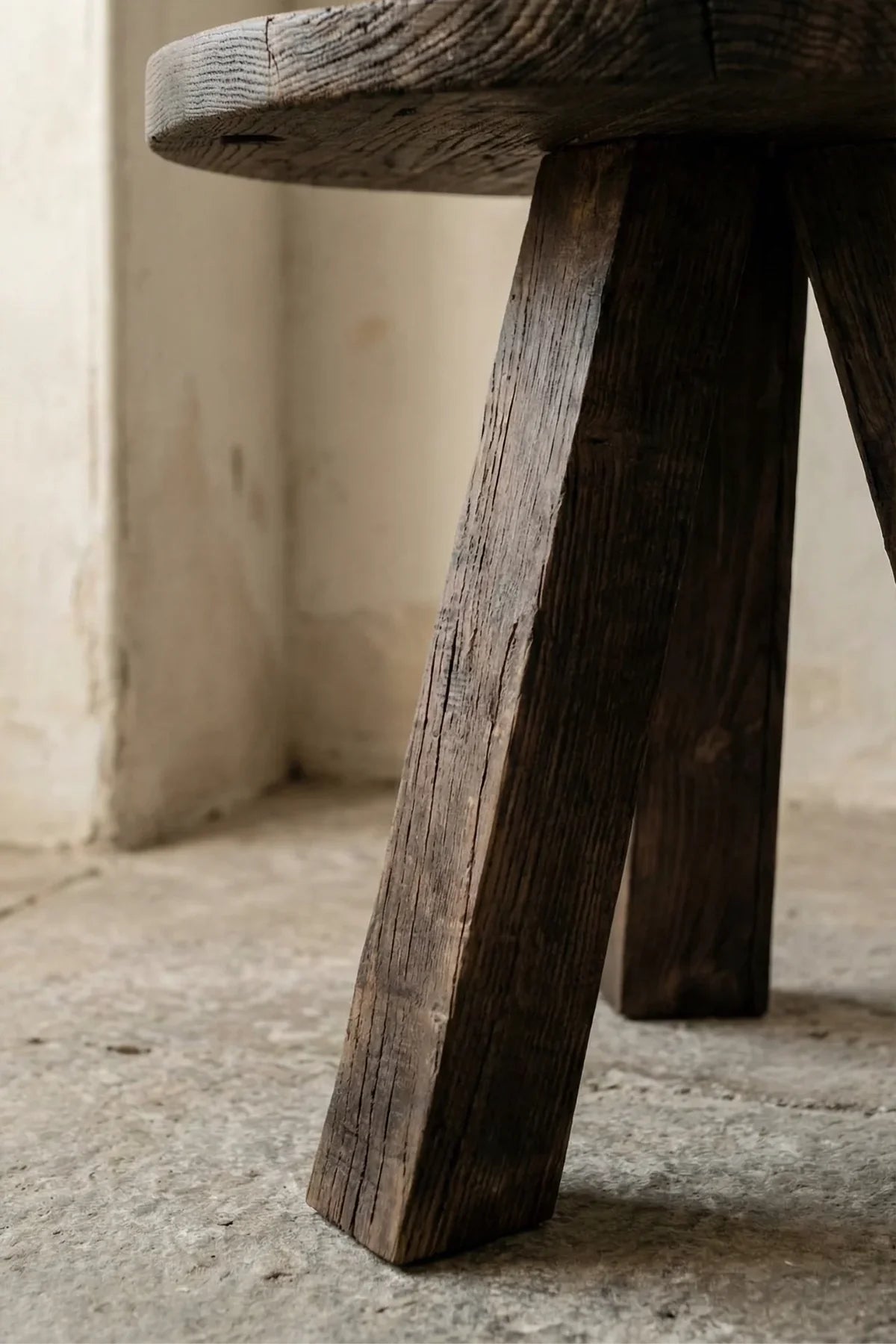 Angled tripod leg base detail of the Tifa reclaimed solid oak side table