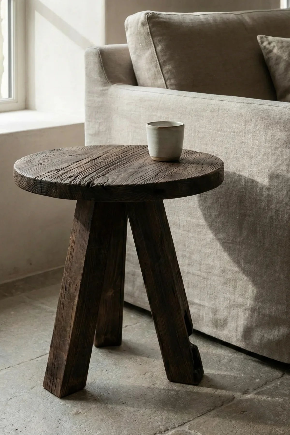 Close-up of Tifa circular tabletop showing lightly brushed reclaimed oak grain and natural knots