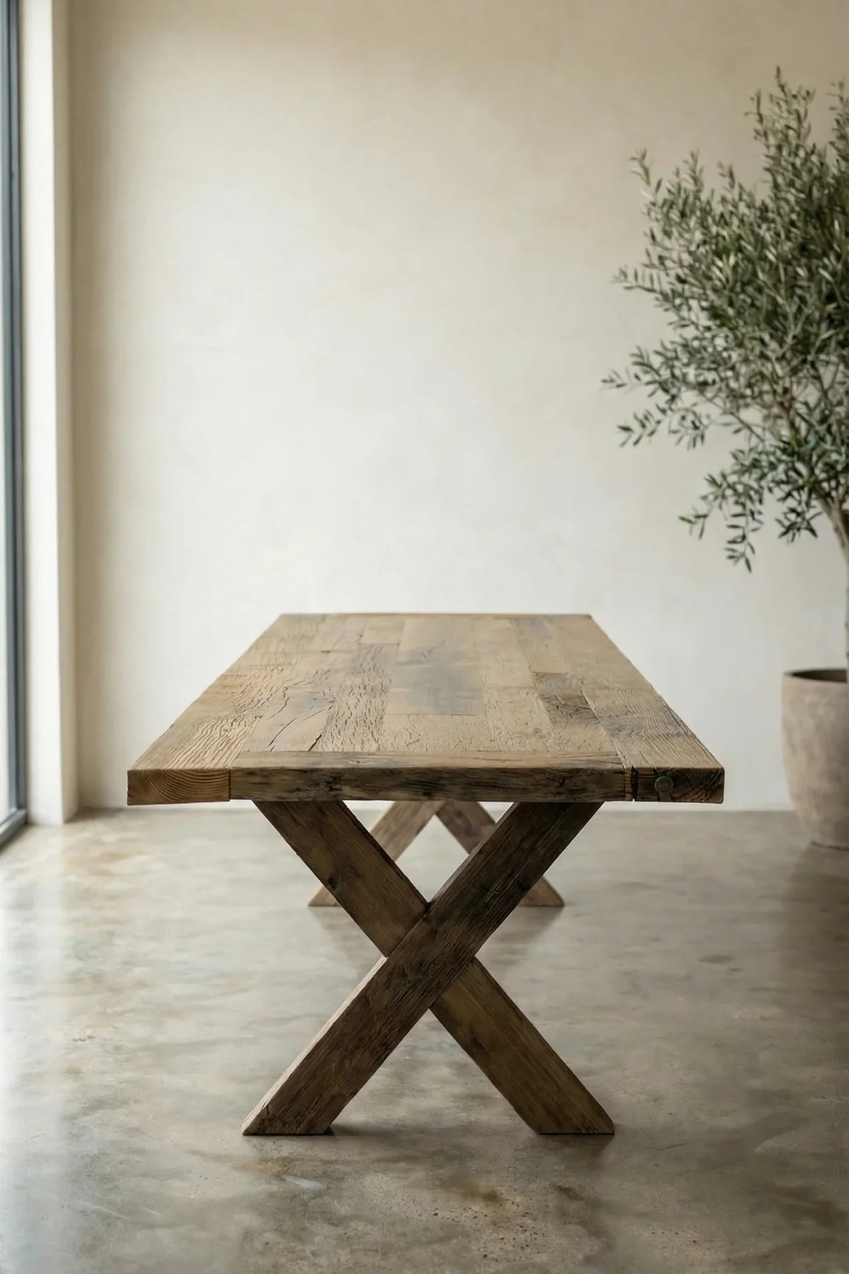 Crossed structural oak beam legs of the Traverse dining table — X-frame joint detail