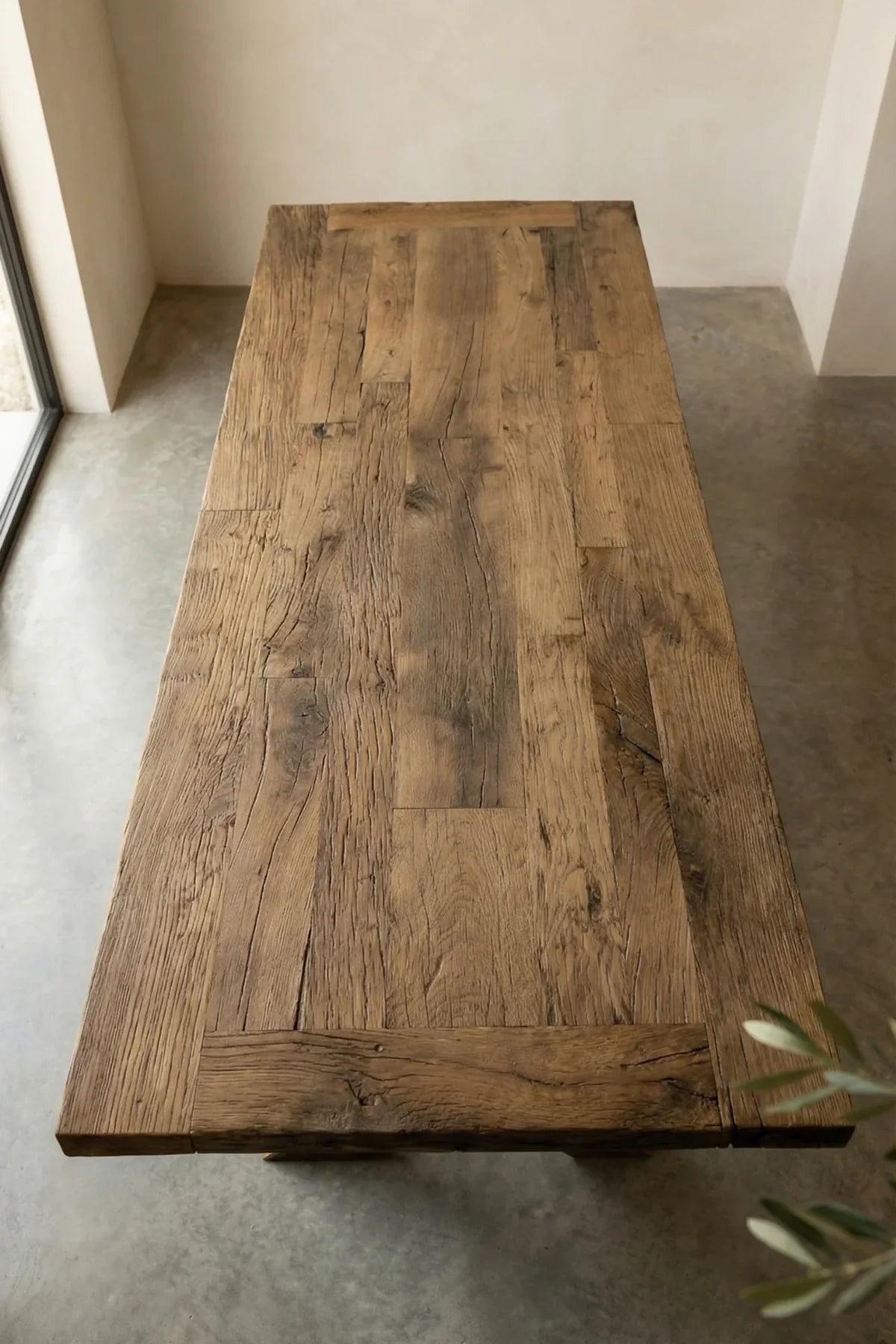 Close-up of Traverse tabletop showing lightly brushed original oak surface with natural knots and weathering
