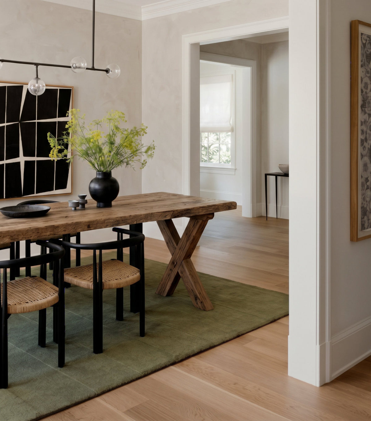 Traverse Reclaimed Oak Dining Table – on a green rug beside a doorway